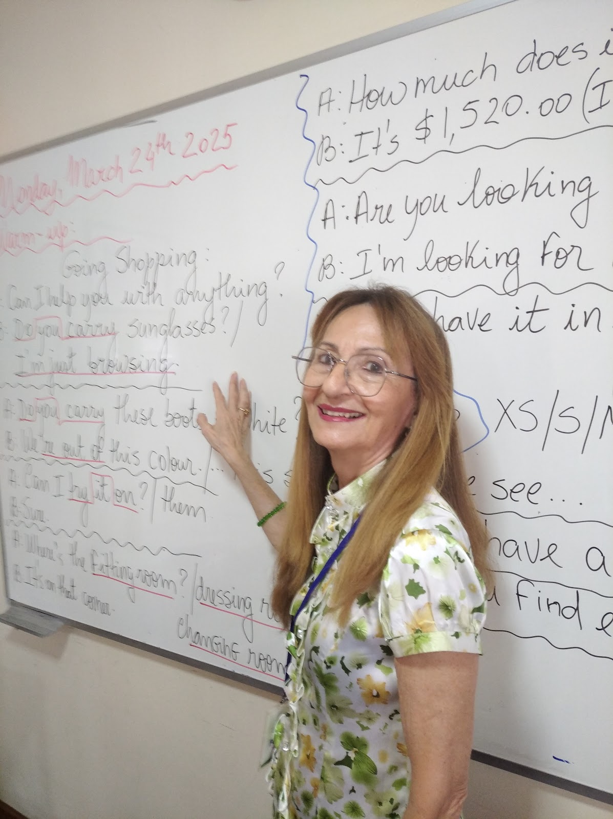 Teacher Mara teaching an English lesson at the whiteboard